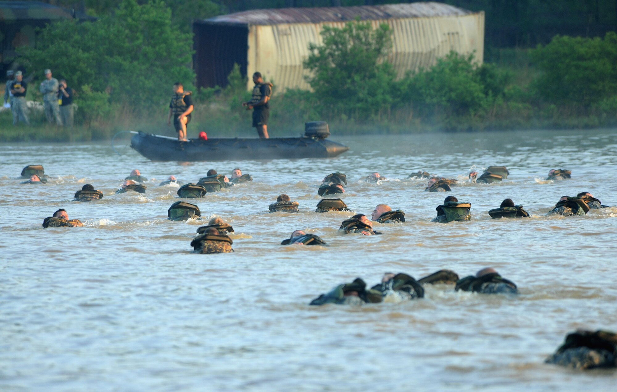 FORT BENNING, Ga. -- Cadres  monitor servicemembers as they swim across Victory Pond here May 7 for the 27th annual David E. Grange Jr. Best Ranger Competition. The competition started in 1981 when the Chairborne Rangers, a civilian organization that supports the Rangers, asked the training department to design and conduct a “Ranger Olympics” in order to identify the best two-man team in the Army. (U.S. Air Force photo by Airman Class Joshua Green/RELEASED)
