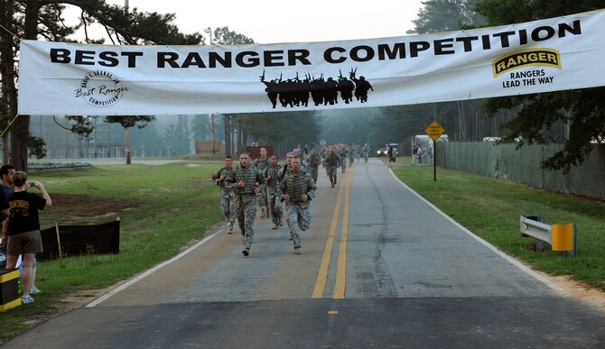 FORT BENNING, Ga. -- 1st Lt. Daniel Norwood, 822nd Security Forces Squadron flight commander, and Master Sgt. Michael Miller, 822nd SFS Bravo Flight sergeant, from Moody Air Force Base, Ga., start with a lead ahead of most of the other participants during the buddy run in the 27th annual David E. Grange Jr. Best Ranger Competition here May 7. This is the first time any Airmen have participated in the competition. (U.S. Air Force photo/Airman Class Joshua Green)