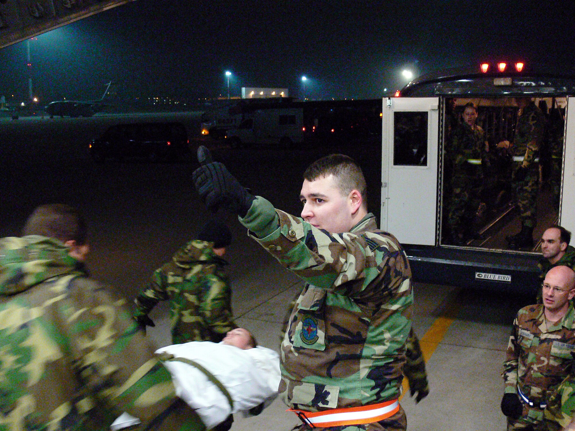 Staff Sergeant Ricky Tackett overseas the loading of a wounded Marine onto a bus destined to Landstuhl Regional Medical Center.  The eleven wounded troops arrived onboard a C-17 following a helicopter crash in Southeast Afghanistan only hours earlier.  SSgt Talbert is medical technician in the 435th Aeromedical Staging Flight from Ramstein Air Base, Germany.