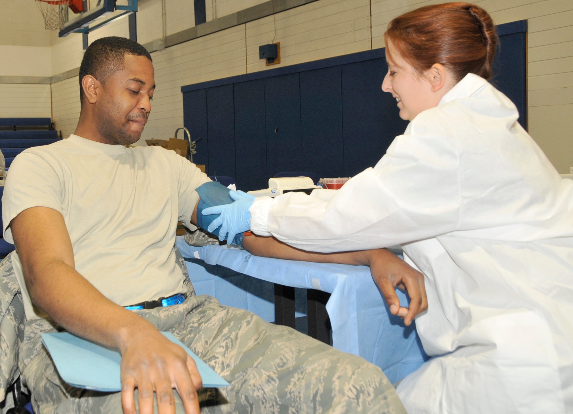 A lab technician volunteer checks the blood pressure of Airman 1st Class Maxo Pierre Component Maintenance Squadron jet engine mechanic, before he is allowed to donate at the Armed Services Blood Bank Center-Europe blood drive at RAFlakenheath May 11. There are at least three stations to go to before actually being allowed to give blood. (U.S. Air Force photo/Airman 1st Class Eboni Knox)