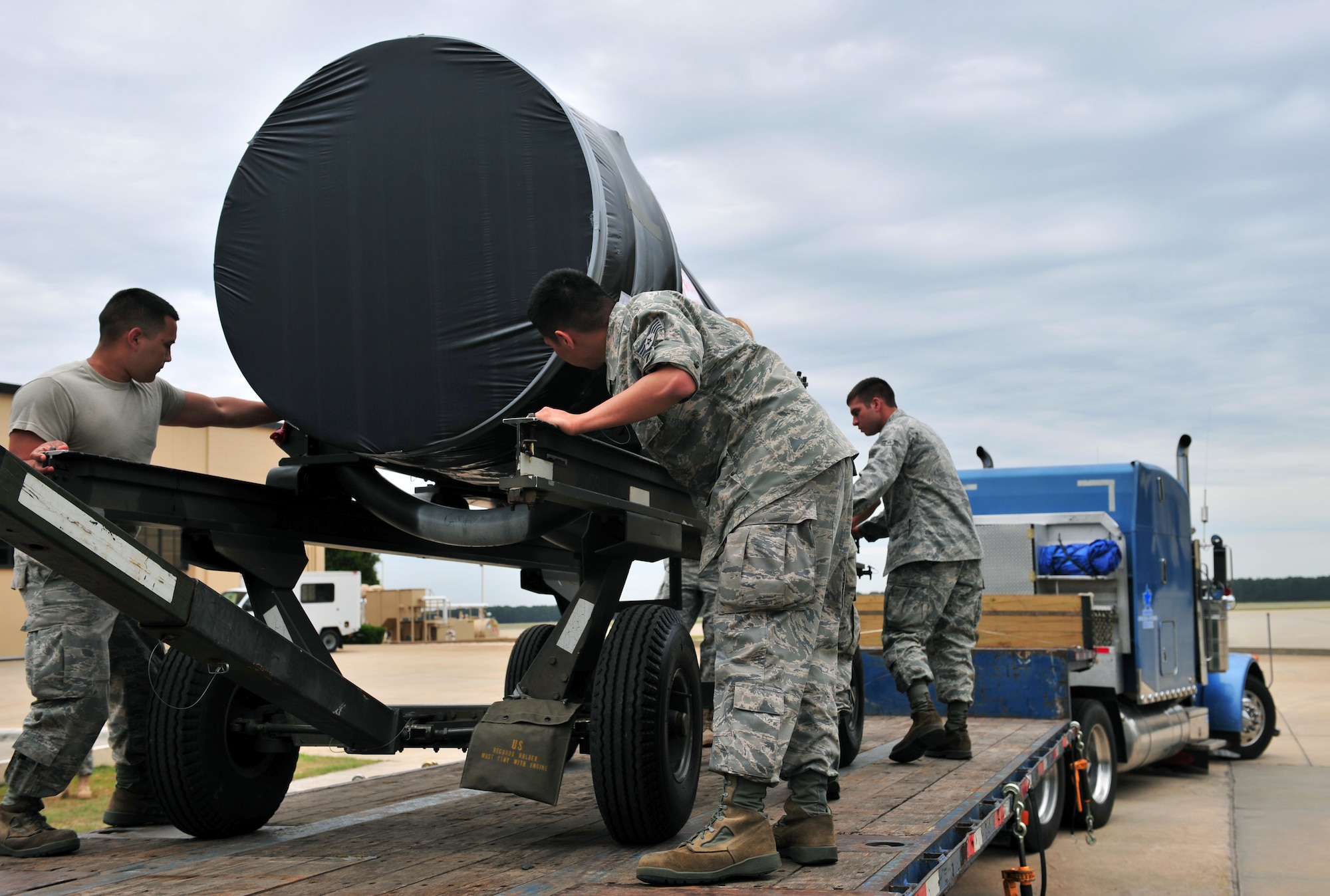 100511-F-8430J-044
SHAW AIR FORCE BASE, S.C. ? Airman 1st Class Matthew Hale (right), Fermin Cabrera (left), and Staff Sgt. Richard Abisia, 20th Component Maintenance Squadron, push a Turbo Fan 34 engine onto a flatbed truck May 11, 2010. This TF34 engine is the final one to be built at Shaw and is scheduled to be shipped to Moody Air Force Base, Ga. (U.S. Air Force photo/Airman 1st Class Amber E. N. Jacobs)


