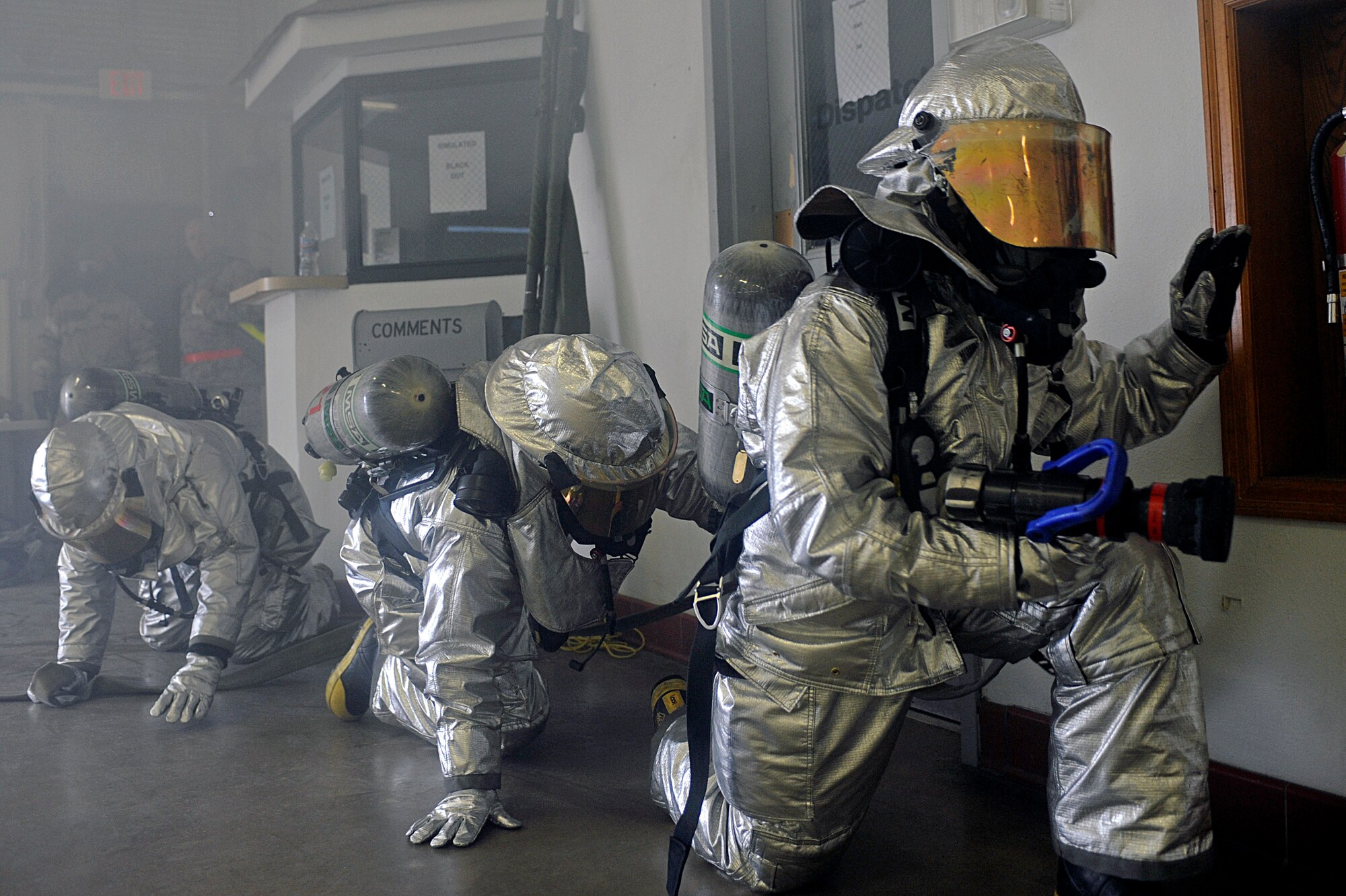ELLSWORTH AIR FORCE BASE, S.D. – (Left to right) Senior Airman Craig George and Airmen 1st Class Taylor Messer and Mitch Carrell, 28th Civil Engineer Squadron firefighters, navigate their way through a simulated fire during a Phase II Operational Readiness Exercise, May 12. During the Phase II ORE, firefighters were tested on their ability to respond to and extinguish fires in a deployed environment. (U.S Air Force photo/Airman 1st Class Matthew Flynn)