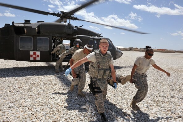 Staff Sgt. Shante Lopez (right) and Senior Airman Austin Hess (left) carry a Soldier on a litter from an aeromedical evacuation area at Forward Operating Base Ghazni, Afghanistan, April 22, 2010. Sergeant Lopez is deployed from the 10th Medical Group at the Air Force Academy in Colorado Springs, Colo. (U.S. Air Force photo/Tech. Sgt. JT May III) 