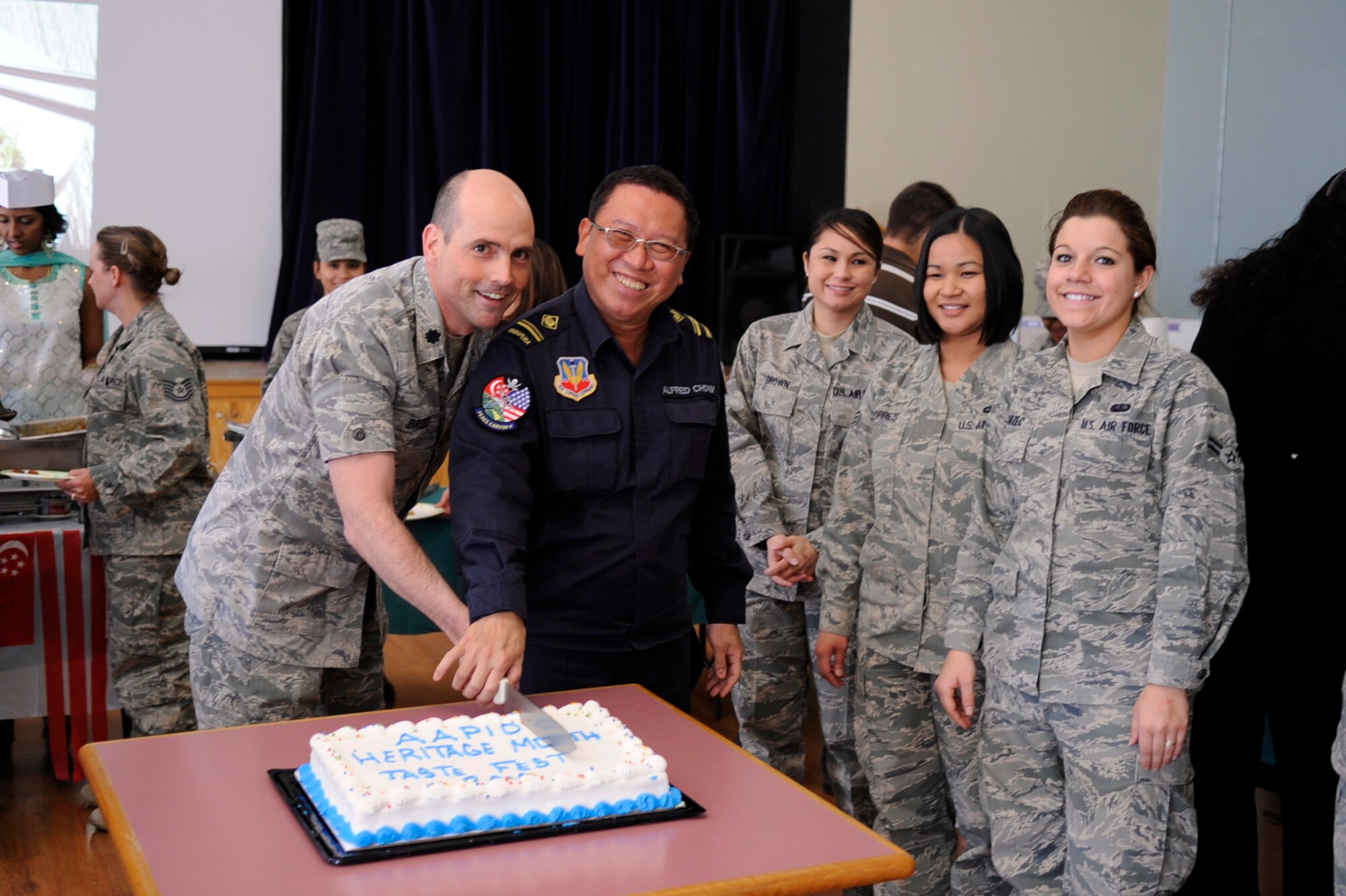 MOUNTAIN HOME AIR FORCE BASE, Idaho – Lt. Col. Peter Breed, 366th Aero Medical Dental Squadron commander, and ME 4 Alfred Chow, 428th Fighter Squadron, bring the Asian Pacific Heritage taste fest to a close by cutting the ceremonial cake May 7. With dishes that spanned all over the Asian-Pacific region gunfighters received the opportunity to taste and experience new things. (U.S. Air force photo by Airman 1st Class Angelina Drake)