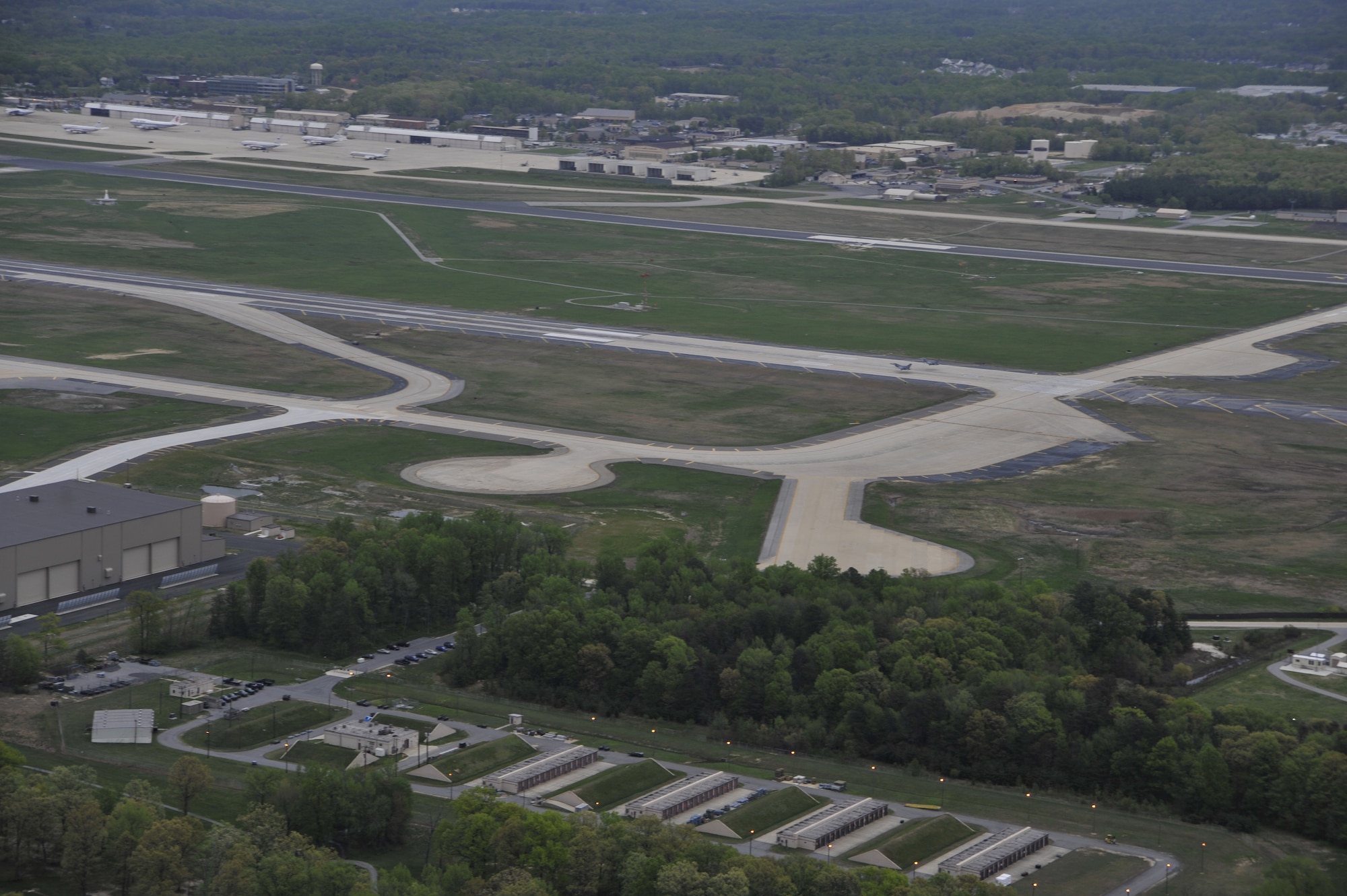 An aerial view of the Andrews AFB, Md., airfield shows the West runway, which is undergoing an $81 million recapitalization and resurfacing project. The repair of the West Runway is just one phase of a comprehensive plan to recapitalize AFDW’s primary weapon system: the airfield at Andrews. The contract was awarded to the construction firm Tutor Perini Corporation and will completely replace the failing 50-year-old West Runway. Physical construction is scheduled to begin in late summer 2010 and will take approximately 365 days to complete.