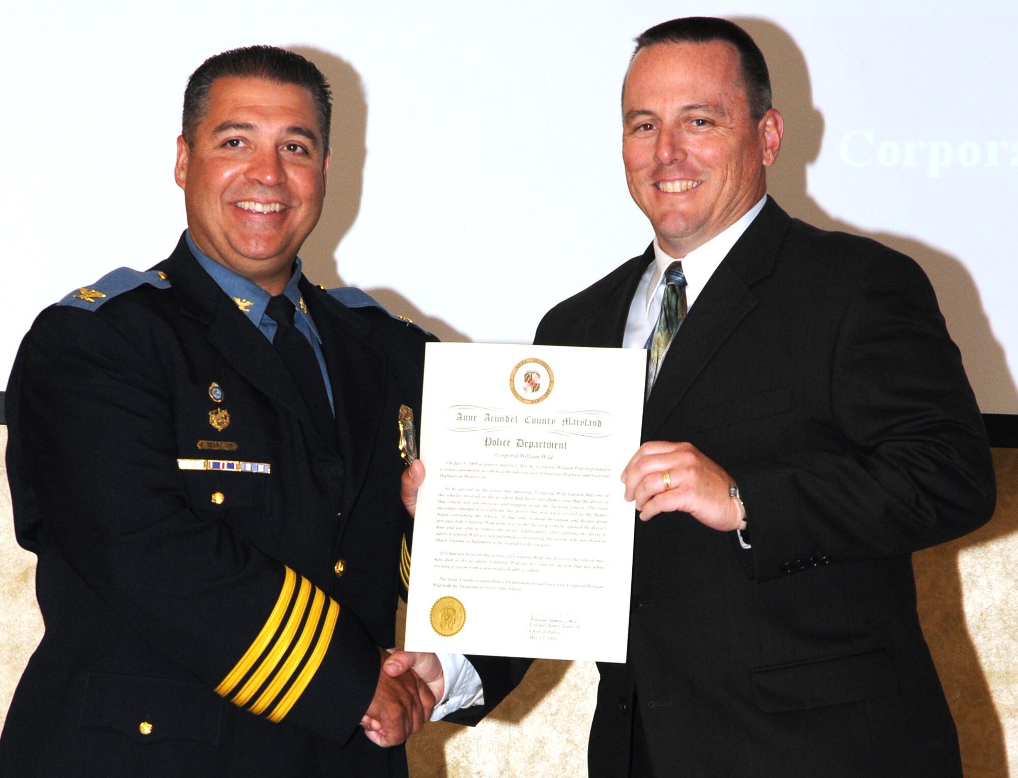 Anne Arundel chief of police Col. James Teare, Sr. (left) presents 512th Airlift Wing Command Chief Master Sgt. William Wild III with the silver star award during the Anne Arundel County Police Foundation's 18th annual awards banquet held in Glen Burnie, Md., May 12. Chief Wild received the silver star award for risking his life to save an individual from their burning vehicle July 3, 2009. (U.S. Air Force photo/Senior Airman Andria J. Allmond)