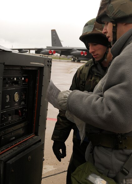 MINOT AIR FORCE BASE, N.D. -- Airman 1st Class Justin Heminger and Staff Sgt. Nathan Jacobson, 5th Aircraft Maintenance Squadron crew chiefs, go through form 244/245 for aircraft ground equipment during the Bomber Strategic Aircraft Recovery Team mobility exercise here May 7. Airman Heminger and Sergeant Jacobson ensured there were no open discrepancies preventing them from using the equipment. (U.S. Air Force photo by Senior Airman Ashley N. Avecilla)
