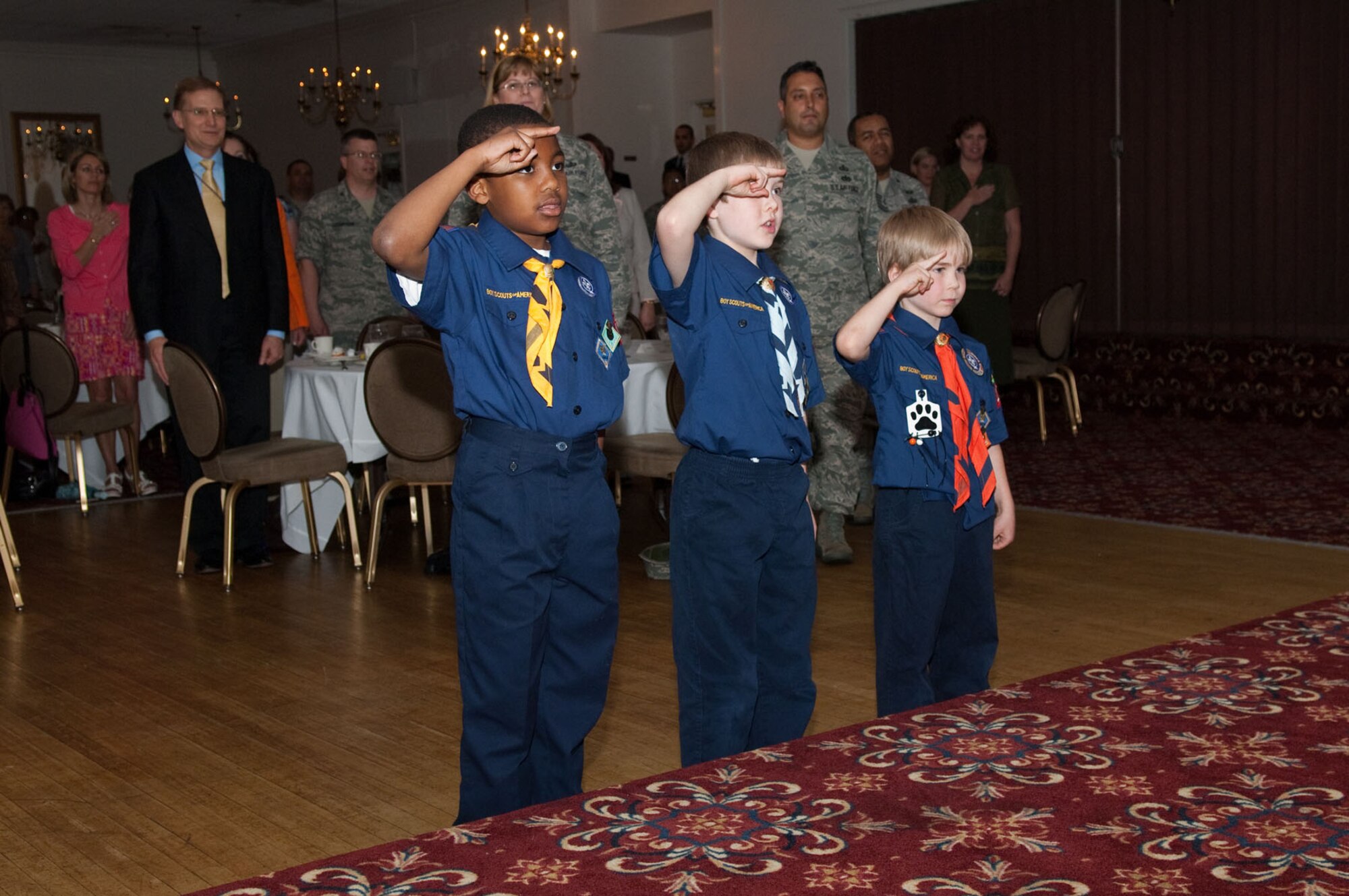 HANSCOM AIR FORCE BASE, Mass. – Boy scouts from Troop 173, (l to r) Zach Fisher, Todd Davis and Eric Davis, salute the flag during the Volunteer Salute at the Minuteman Club on May 6. The salute honored the efforts of all volunteers at Hanscom AFB. Four people were recognized with the Chief of Staff of the Air Force Volunteer Excellence Award for their service to the base during the ceremony. They were Ms. Michelle Theriault, Ms. Jessie Peacock Thompson, retired Lt. Col. Jeffrey Rattray and Dr. Ruth Wrigley (U.S. Air Force photo by Rick Berry)