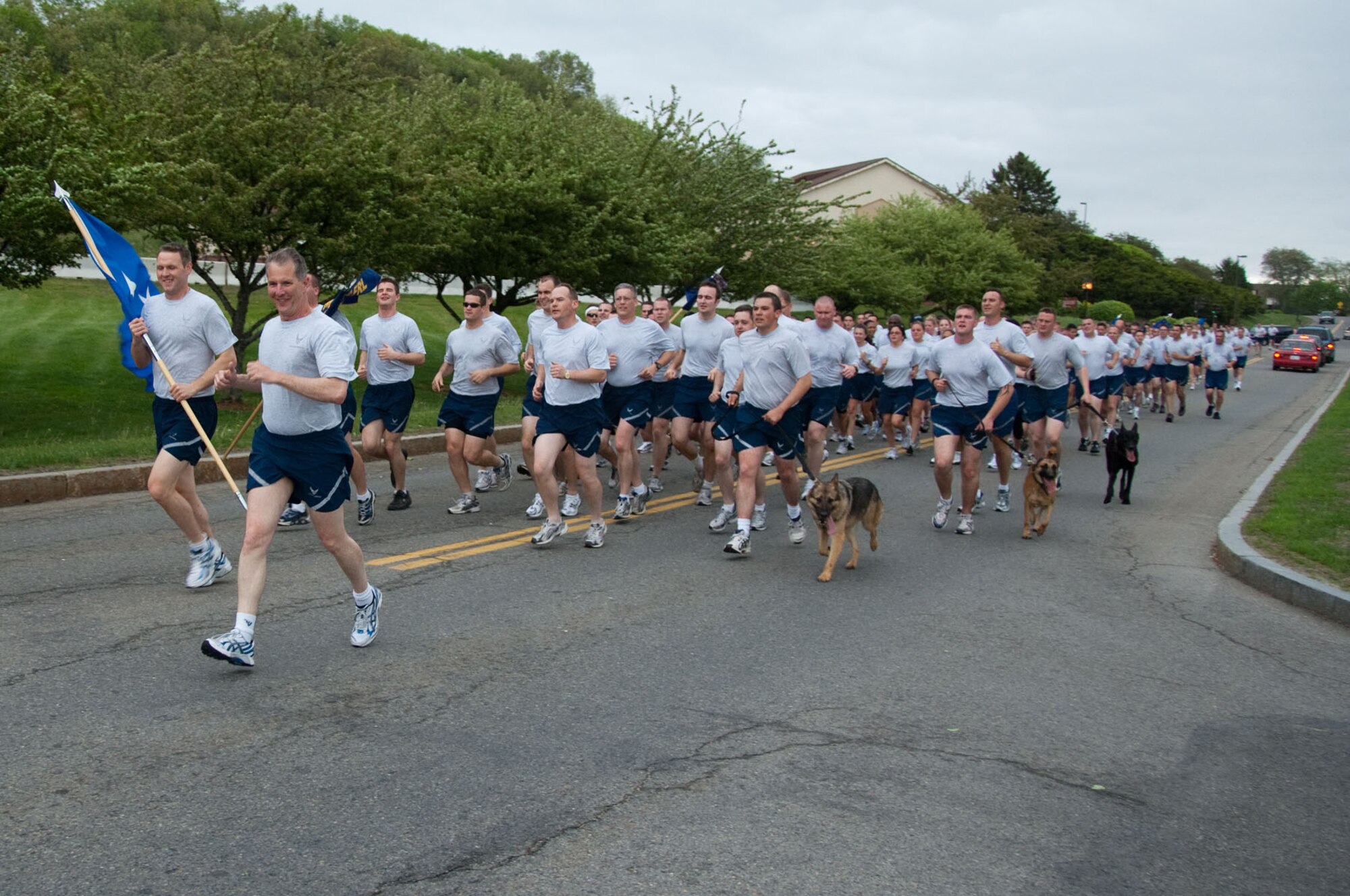 HANSCOM AIR FORCE BASE, Mass. – Lt. Gen. Ted F. Bowlds (front), Electronic Systems Center commander, participates in a formation run along with Airmen from across the base as part of the opening ceremony for Hanscom Olympics on May 3. ESC Staff won both the Olympics and the Commander's Cup. The 66th ABW came in second and the 653rd Electronic Systems Wing placed third. (U.S. Air Force photo by Rick Berry)