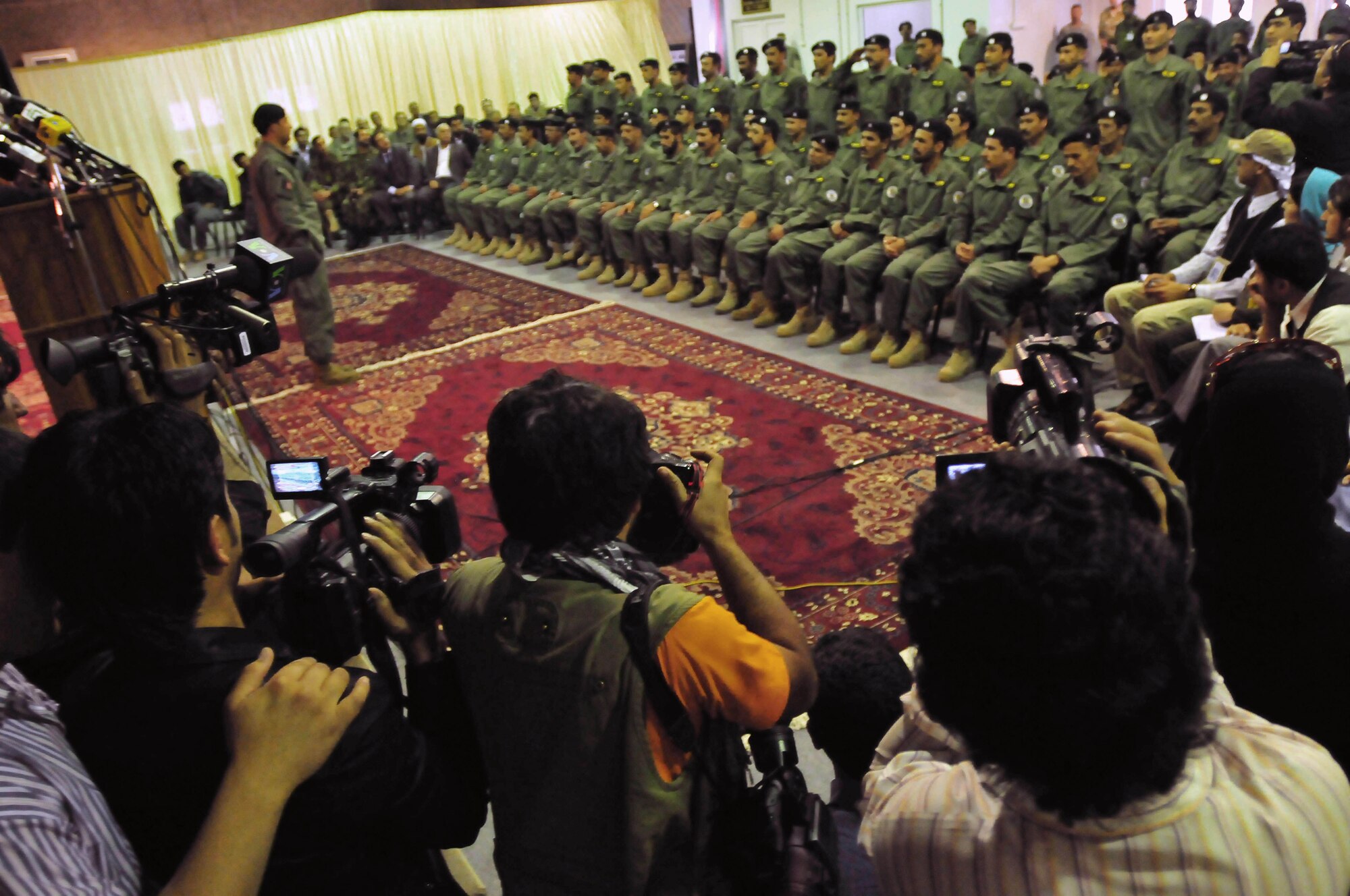 Afghan soldiers of the Ministry of Interiors Air Interdiction Unit listen to speeches and are photographed by local and international press during a transition ceremony held at the conference center on the Afghan National Army Air Corps base in Kabul, Afghanistan, May 5, 2010. The ceremony was held to recognize several achievements made by the AIU in the last 12 months. (US Navy photo by Mass Communication Specialist 2nd Class David Quillen/ RELEASED).