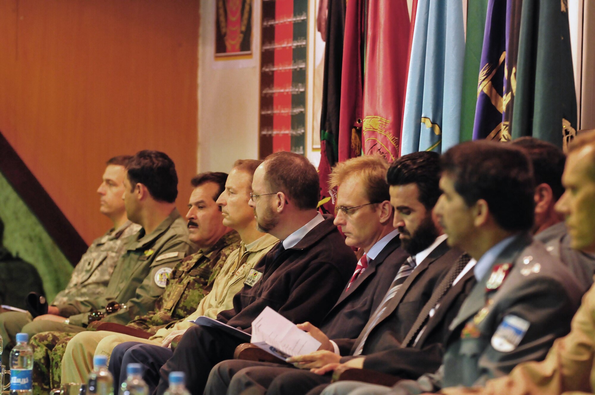 Lt. Col. Ronald L. Ells, commanding officer, Air Interdiction Unit Embedded Training Team, left, Col. Fahim Ramin, commanding officer AIU, General Darwan, commanding general, Afghan National Army Air Corps, Brig. Gen. Michael Boera, commanding general, Combined Air Power Transition Force, Dr. Jack Kem, deputy commander, NATO Training Mission Afghanistan, Mr. Tom Dodd, deputy ambassador to the United Kingdom, Deputy Minister Daud, deputy minister counter narcotics, Ministry of Interior, right, sit on stage at a transition ceremony held at the conference center on the Afghan National Army Air Corps base in Kabul, Afghanistan, May 5, 2010. The ceremony was to mark several achievements made by the AIU in the last 12 months. (U.S. Navy photo/Mass Communication Specialist 2nd Class David Quillen/RELEASED)

