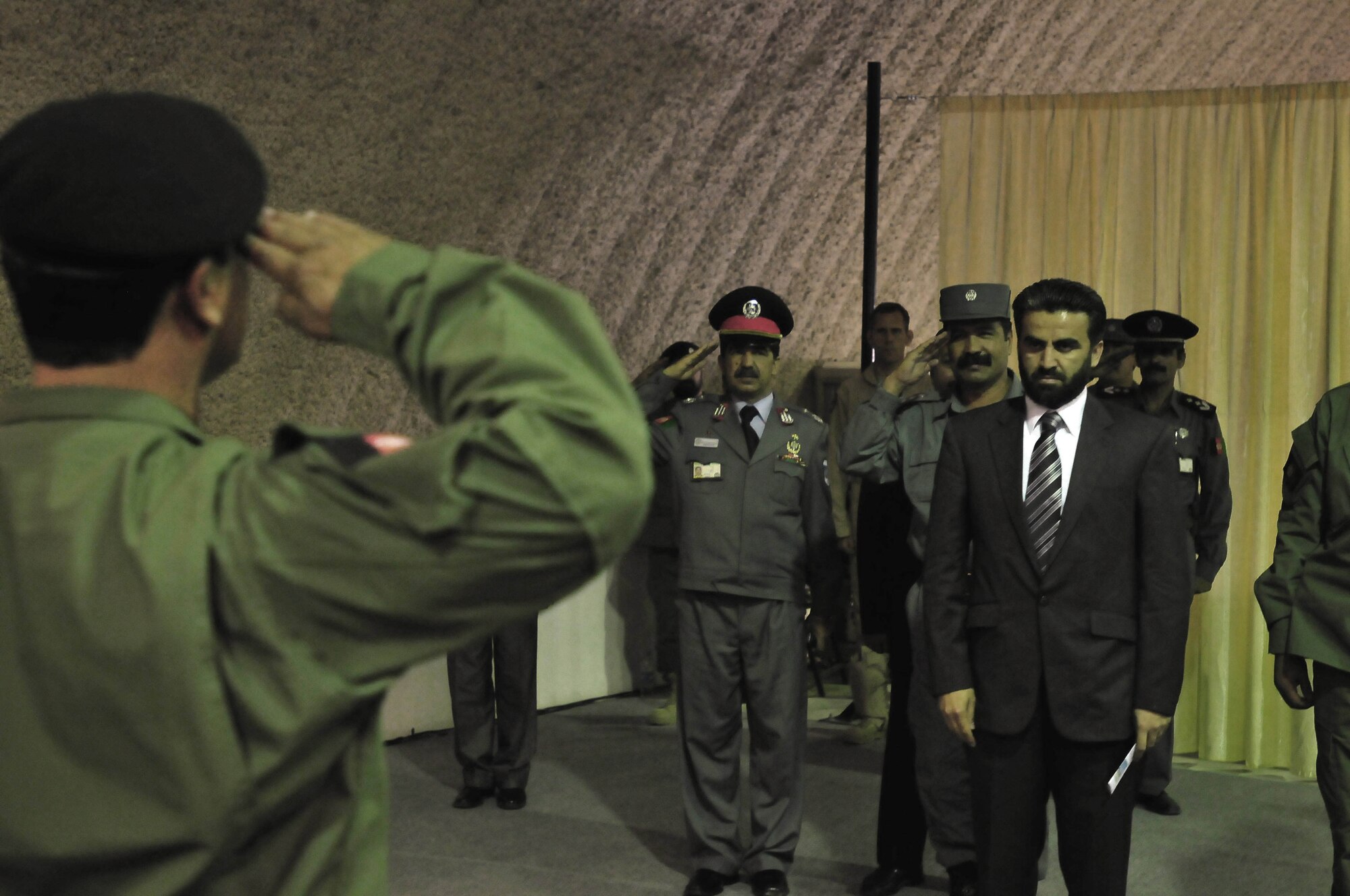 100505-N-6031Q-001 KABUL, Afghanistan ? Col. Fahim Ramin, Commanding Officer, Air Interdiction Unit, salutes Deputy Minister Daud, Deputy Minister Counter Narcotics, Ministry of Interior, prior to the commencement of a transition ceremony held at the conference center on the Afghan National Army Air Corps base in Kabul, Afghanistan on May 5, 2010. The ceremony was to mark several achievements made by the AIU in the last 12 months. (US Navy photo by Mass Communication Specialist 2nd Class David Quillen/ RELEASED).