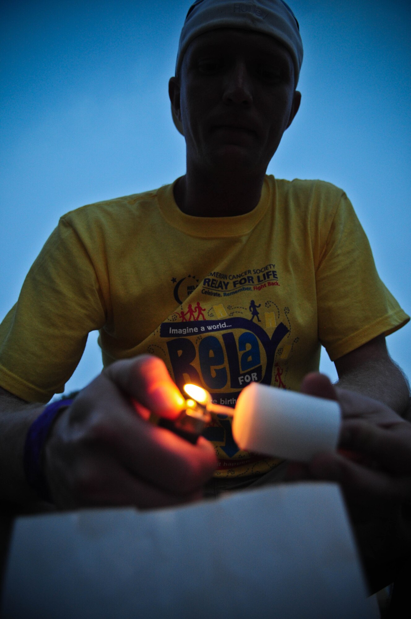 Staff Sgt. Stephen Day, Relay for Life fundraising coordinator, lights a candle during the luminary ceremony Saturday, May 8, 2010 at Arkadas Park at Incirlik Air Base, Turkey during the Relay for Life event.  The luminary ceremony is held to honor cancer survivors and those who have passed away.  (U.S. Air Force photo/Senior Airman Ashley Wood)