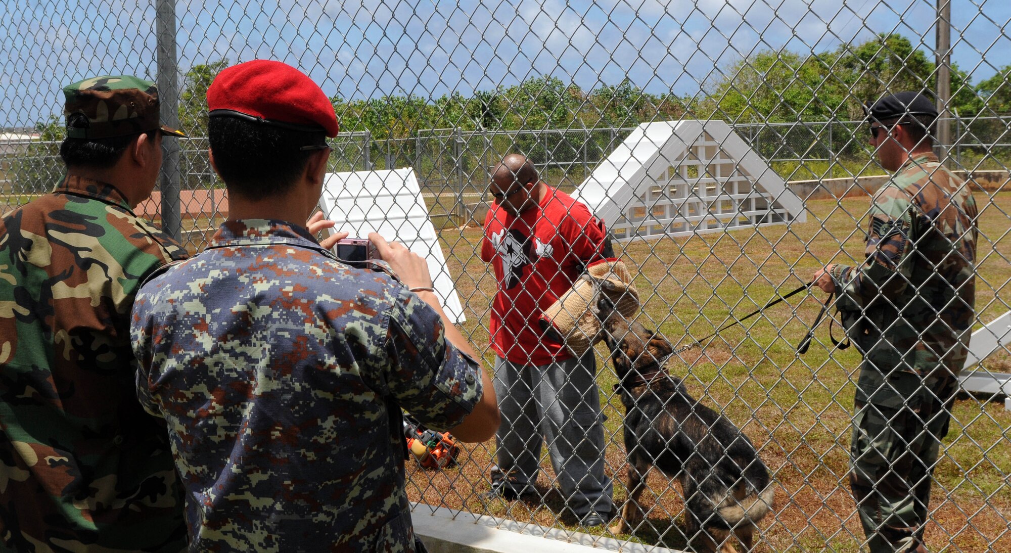 ANDERSEN AIR FORCE BASE, Guam ? Senior security forces personnel from the Pacific Air Forces and 13th Air Force co-hosted the Subject Matter Expert Exchange (SMEE) May 10-13 here. The SMEE is a multinational military information sharing event that provides a forum for mid-level officers from regional security services to exchange views and establish international and interpersonal relationships. The goal of the exchange is to establish integrated base defense and force protection cooperation with select Asian-Pacific nations. The SMEE is held quarterly and invites two members each from select nations. The latest one featured officers from the nations of Cambodia, Indonesia, and Thailand. The exchange includes briefings by experts in many fields of force protection and security forces, including Air Force Office of Speccial Investigations agents, 36th Security Forces Squadron Commander Maj. Sarah Babbitt, 36th Contingency Response Group Commander Col. Daniel Settergren, and 736th Security Forces Squadron Commander Maj. Kirk Hughes. The SMEE attendees also participated in demonstrations of training and fighting capabilities including the K-9 unit, tactical weapons, and simunitions. (U.S. Air Force photos by Airman 1st Class Julian North)