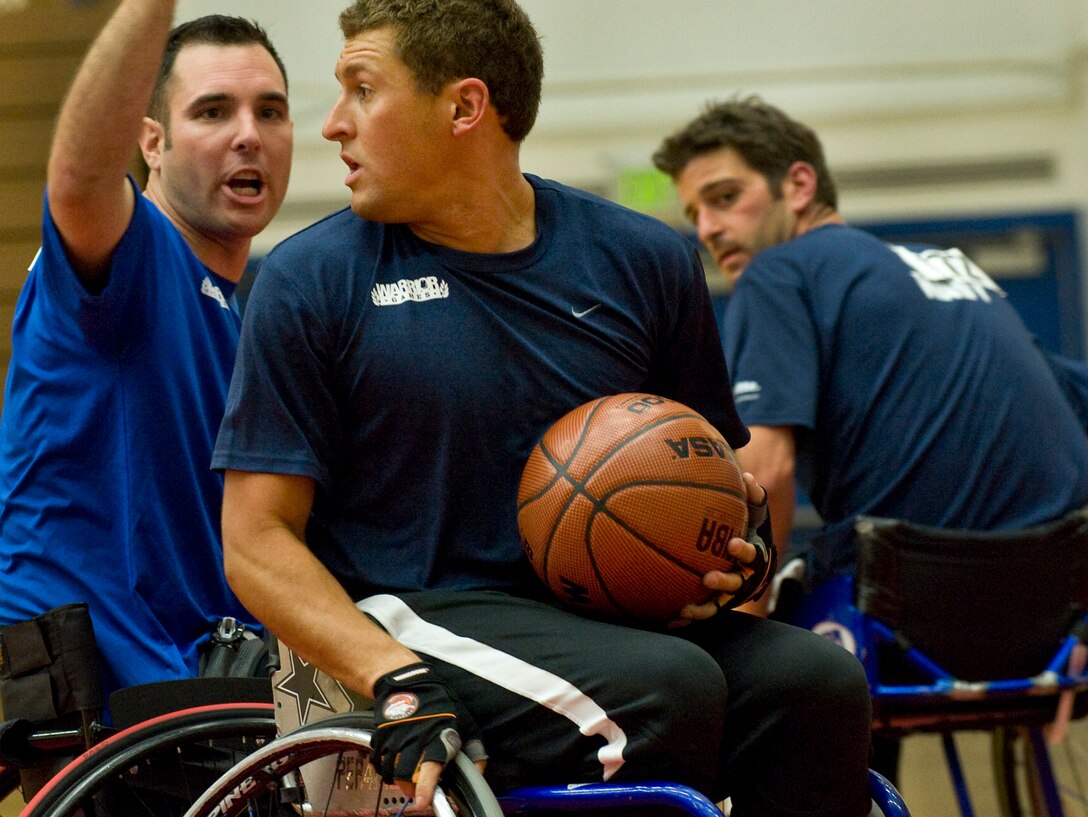 A Navy basketball player looks for an open teammate during the Warrior