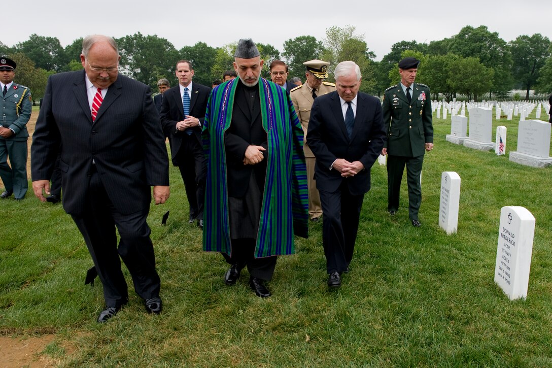 Left to right, John Metzler, superintendent of Arlington National Cemetery, Afghan President Hamid Karzai, and U.S. Defense Secretary of  Robert M. Gates tour the cemetery's Section 60, Arlington, Va., May 13, 2010.