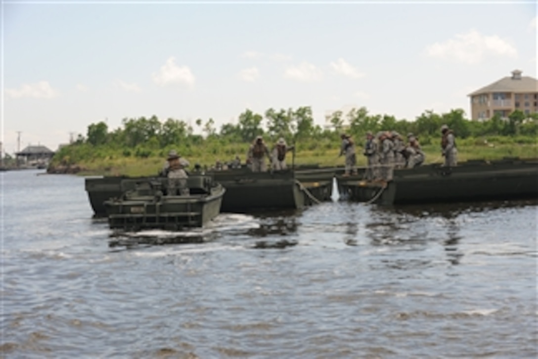 U.S. Army soldiers with the 2225th Multi-Role Bridge Company, 205th Engineer Battalion construct a 300-foot temporary wharf at Campo’s Marina that will be used to load boats with booms and supplies in response to the April 20 Deepwater Horizon oil spill in St. Bernard, La., on May 6, 2010.  