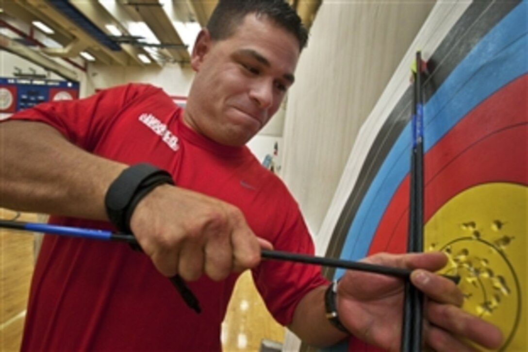 U.S. Marine Corps Cpl. Beau Parra, with the Wounded Warrior Detachment – Hawaii, retrieves his game winning shot from the target during the inaugural Warrior Games archery competition at the Olympic Training Center, Colorado Springs, Colo., May 12, 2010. Parra, a 28-year-old Prescott, Ariz., native, shut out the competition winning the gold medal in the compound bow competition.