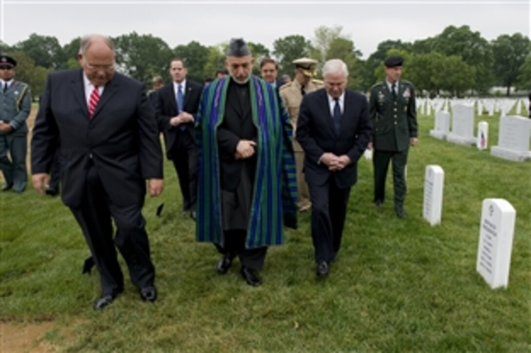 Defense Secretary Robert M. Gates, right, Afghanistan President Hamid Karzai and John Metzler, superintendent, Arlington National Cemetery, tour the cemetery's Section 60, Arlington, Va., May 13, 2010.