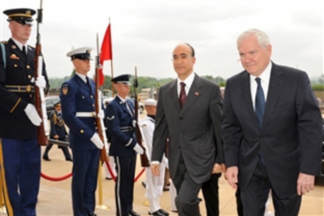 U.S. Defense Secretary Robert M. Gates, right, escourts Tunisian Defense Minister Ridha Grira through an honor cordon into the Pentagon, May 13, 2010. The two defense leaders will meet to discuss bilateral security issues.