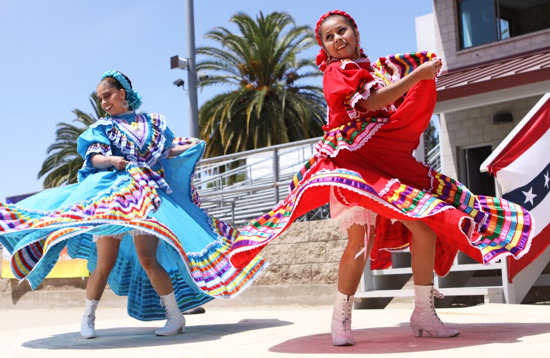 Elida Ocegura (right), and Elizabeth Juarez (left), perform a traditional Mexican Ballet Folklorico Tapatio dance during Camp Pendleton’s 5th Annual Multicultural Day celebration at the 11 Area field, May 13. During the 4-hour affair, themed “Celebrate America,” local residents had the opportunity to visit more than 20 booths, filled with everything from foreign cuisines to cultural souvenirs.