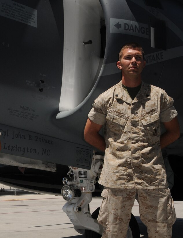 Cpl. Jonathan Prince, Marine Attack Squadron 214 powerline mechanic, stands in front of the squadron commander's AV-8B Harrier with his name painted on the gear doors May 13, 2010, at the Marine Corps Air Station in Yuma, Ariz. “Not a lot of people get to have their names on the plane,” said Prince, 23, smiling as he looked at the polished Harrier outside the squadron’s hangar. Prince's name was painted on the jet because of his abilities as plane captain. During his deployment to Afghanistan, Prince, a native of Lexington, N.C., located an engine problem that nearly went undiscovered. The damage was such that the Harrier, and its pilot, may have been lost.