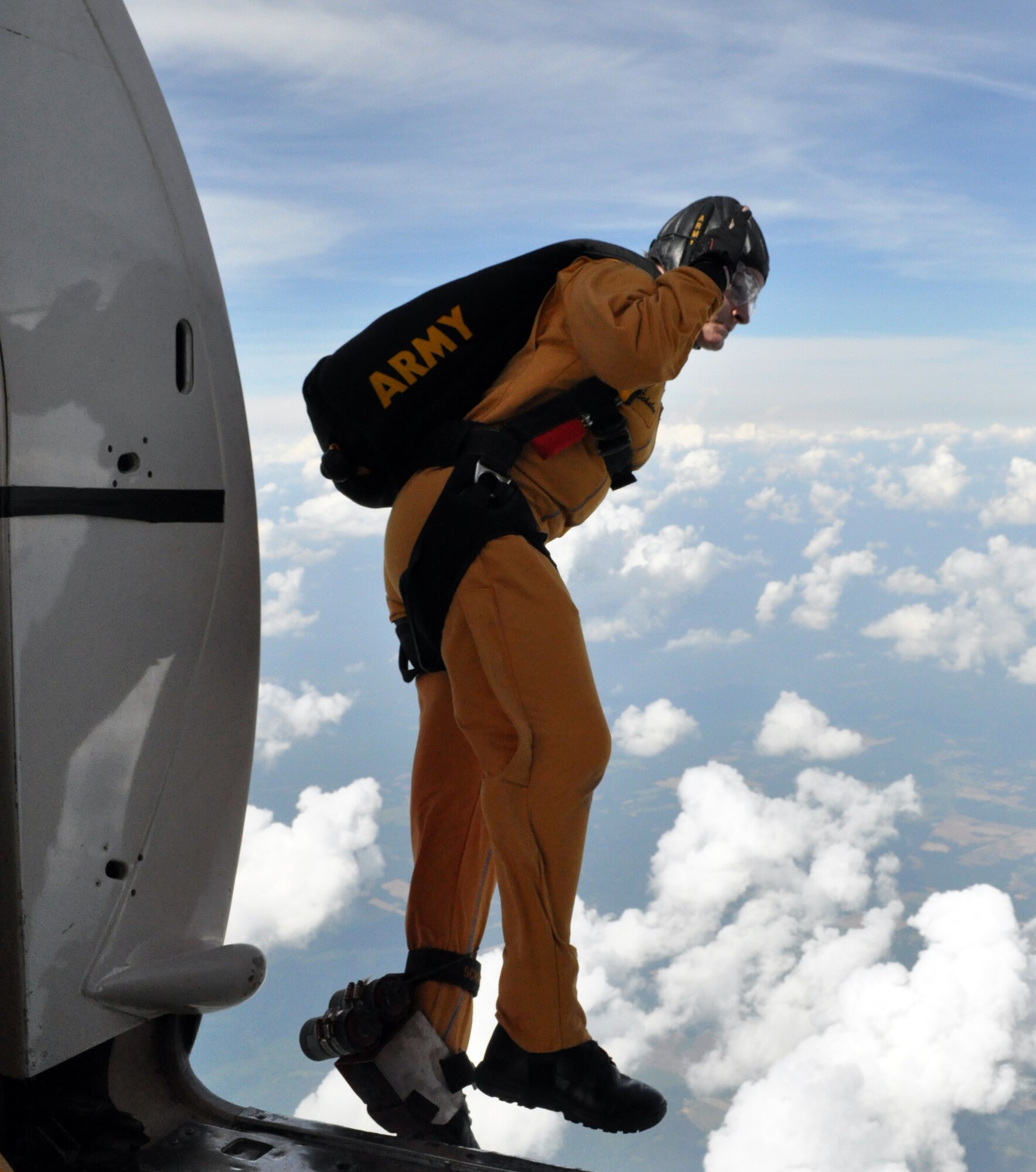 Army Sgt. Jennifer Schaben jumps during a practice demonstration at Columbus Air Force Base May 14. Sergeants Schaben is a member of the U.S. Army Golden Knights Parachute Demonstration Team and are taking part in Wings over Columbus 2010. (U.S. Air Force photo/Senior Airman Jacob Corbin)