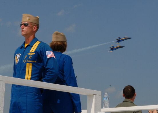 100514-N-9565D-143 JOINT BASE ANDREWS, Md. (May 14, 2010) -  LT. C.J. Simonsen, assigned to the U.S. Navy's flight demonstration team, the Blue Angels, awaits for his narration cue from LCDR Amy Tomlinson while two of the  F/A-18 Hornets assigned to the squadron fly past show center.  This is the first Joint Service Open House conducted by Team Andrews members at the newly minted Joint Base Andrews, continuing a rich tradition of parternship and strength rooted in service to the nation.  (U.S. Navy photo by Mass Communication Specialist 2nd Class Clifford L. H. Davis)