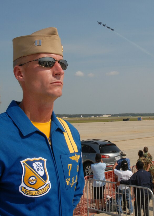 100514-N-9565D-140 JOINT BASE ANDREWS, Md. (May 14, 2010) -  LT. C.J. Simonsen, assigned to the U.S. Navy's flight demonstration team, the Blue Angels, watches the crowd while four of the F/A-18 Hornets assigned to the squadron fly past show center.  This is the first Joint Service Open House conducted by Team Andrews members at the newly minted Joint Base Andrews, continuing a rich tradition of parternship and strength rooted in service to the nation.  (U.S. Navy photo by Mass Communication Specialist 2nd Class Clifford L. H. Davis)