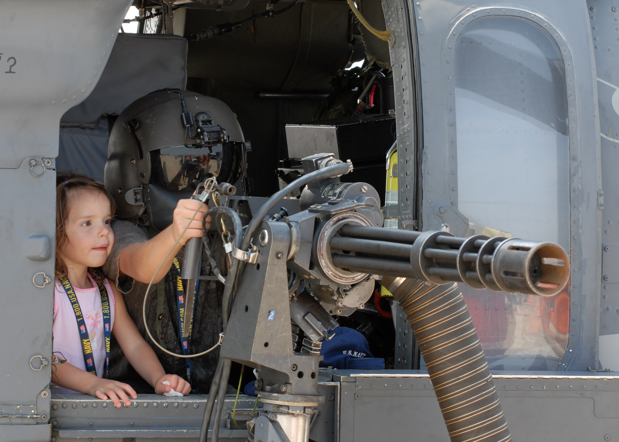 100514-N-9565D-014 JOINT BASE ANDREWS, Md. (May 14, 2010) - Two children check out the air show through the gun sights of an HH-60G Pave Hawk while visiting the Joint Service Open House at Joint Base Andrews on May 14.  This is the first Joint Service Open House conducted by Team Andrews members at the newly minted Joint Base Andrews, continuing a rich tradition of parternship and strength rooted in service to the nation.  (U.S. Navy photo by Mass Communication Specialist 2nd Class Clifford L. H. Davis)