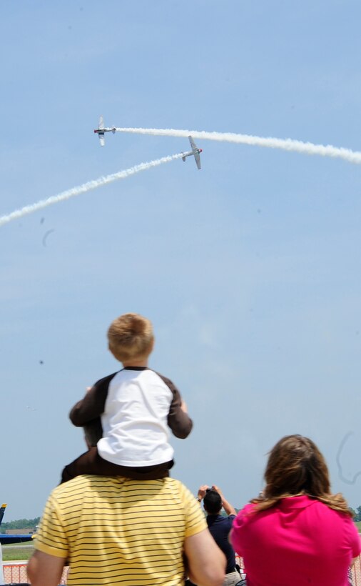 JOINT BASE ANDREWS, Md. - Spectators look on as the GEICO Skytypers perform at the 2010 Joint Service Open House hosted here, May 14. This year's event will have demonstrations by the Navy Blue Angels and the Army Golden Knights. JSOH is planned and conducted by Total Force; Active, Guard, Reserve, civilian employees, as well as retirees and families.(U.S. Air Force photo by Staff Sergeant Keyonna Fennell)
