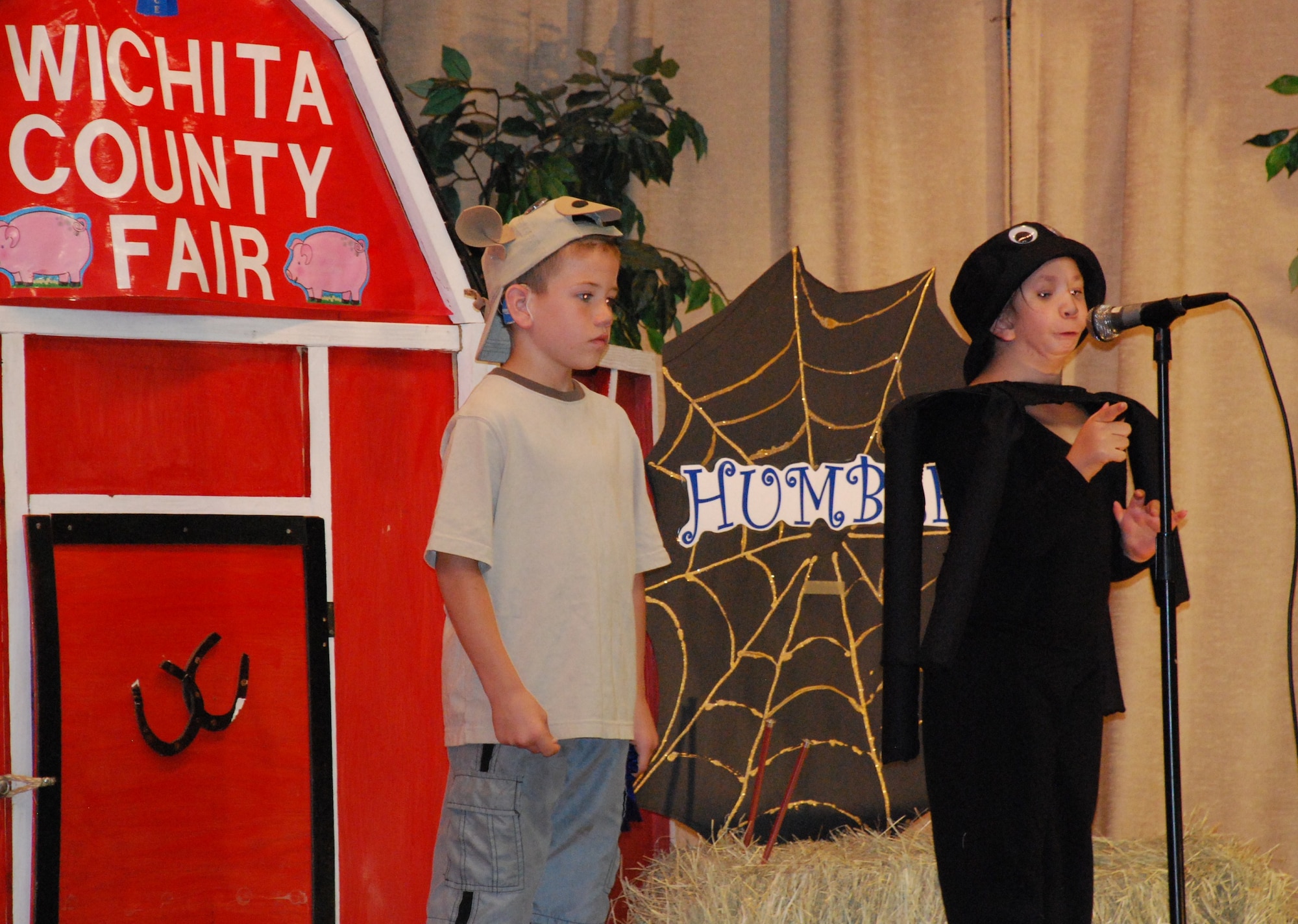 During the Cunningham Elementary School Deaf Education Program, students perform “Charlotte’s Web”.  Second-graders Caedon Mead (left) and Candyce Tamez (right) portray Wilbur the pig and Charlotte the spider May 13, 2010.  The Deaf Education Program students sang the national anthem and performed the play "Charlotte’s Web" for Sheppard Elementary School to demonstrate their form of communication, sign language.  (U.S. Air Force photo/Tech Sgt. Vernon Cunningham)