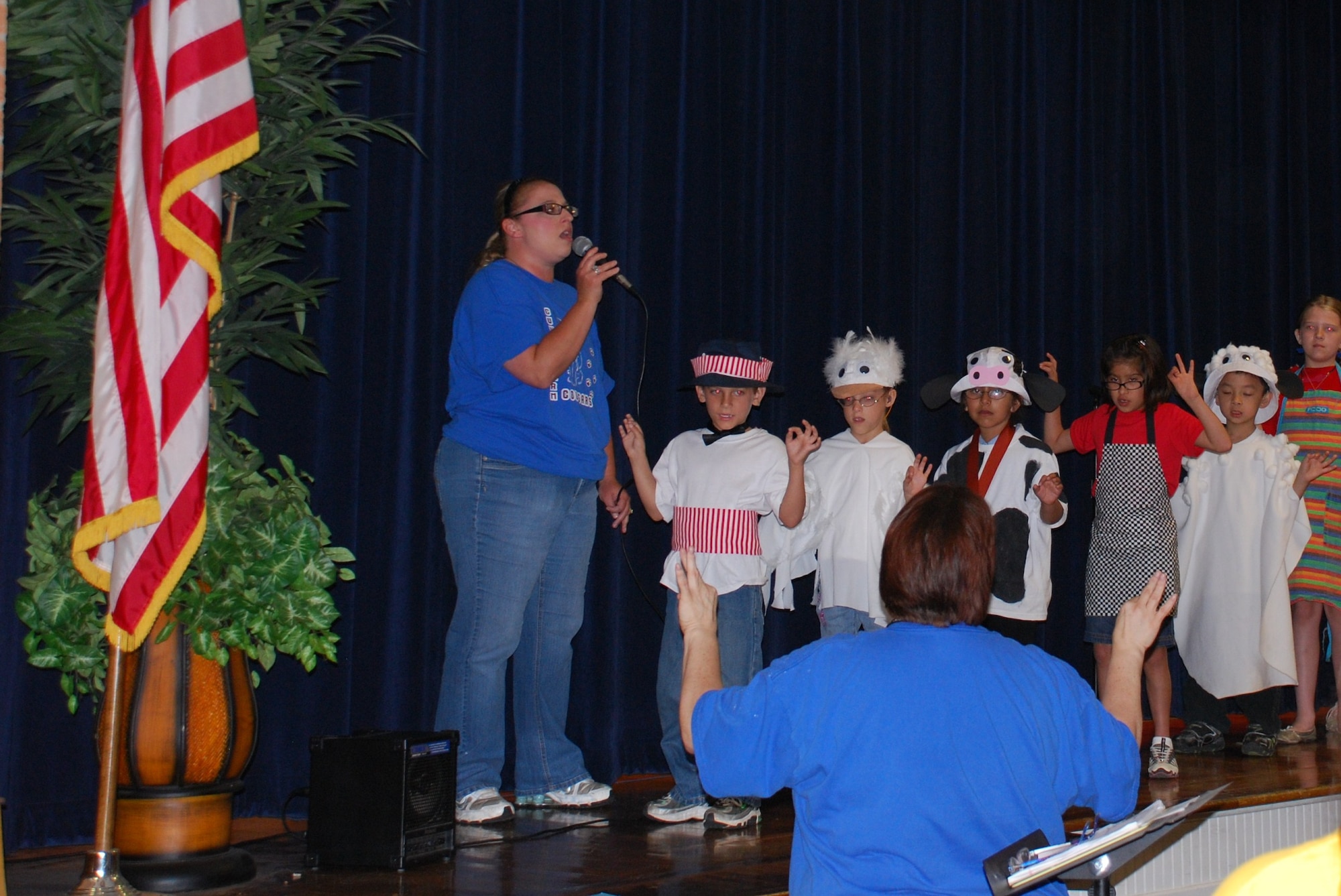 Cunningham Elementary School Deaf Education Program students use sign language to communicate the words to the “Star Spangled Banner” as Elisa Ojeda (left), assistant with Cunningham Elementary, sings during their opening performance at Sheppard Elementary School May 13, 2010.  The Deaf Education Program students sang the national anthem and performed the play ‘"Charlotte’s Web" for Sheppard school children to demonstrate their form of communication, sign language.   (U.S. Air Force photo/Tech Sgt. Vernon Cunningham)