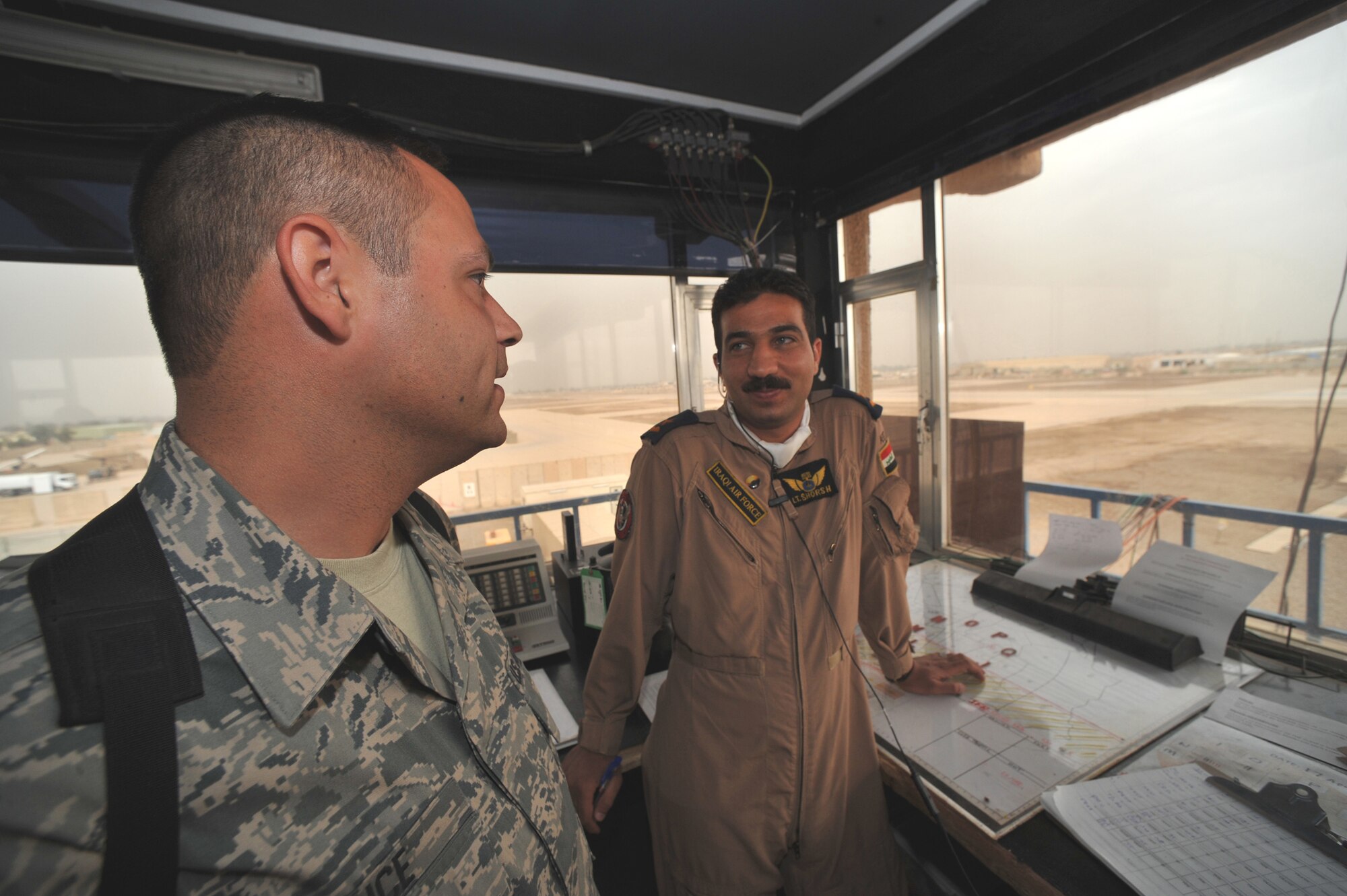 Staff Sgt. Shannon Grice talks recently with 2nd Lt. Shorsh, Iraqi air force trainee, about air traffic control at Camp Taji, Iraq.  The Iraqi Training and Advisory Mission is in the process of transferring all operations to the Iraqi military for the U.S. drawdown.  Sergeant Grice is assigned to the 347th Operational Support Squadron at Yokota Air Base, Japan.  (U.S. Air Force photo/Staff Sgt Quinton Russ)