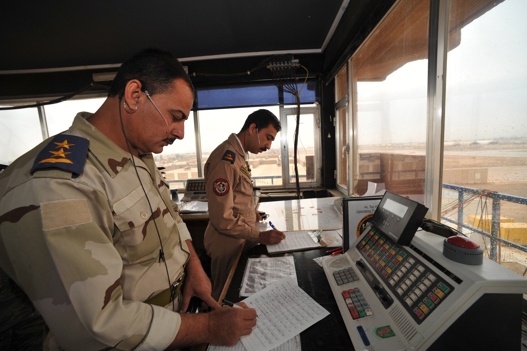 Iraqi air force air traffic controllers 1st Lt. Mortida (left) and 2nd Lt. Shorsh take notes recently on positions of other aircraft at Camp Taji, Iraq. (U.S. Air Force photo/Staff Sgt Quinton Russ)