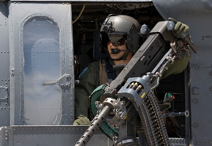 NELLIS AIR FORCE BASE, Nev. -- Staff Sgt. Kevin Darosa, Aerial Gunner assigned to the 66th Rescue Squadron, waits to take off as part of a scramble exercise at the Nellis flight line, May 13. The primary mission of the 66th Rescue Squadron is to provide rapidly deployable, expeditionary combat search and rescue forces to theater commanders in response to contingency operations worldwide. (U.S. Air Force Photo by Airman 1st Class Brett Clashman)