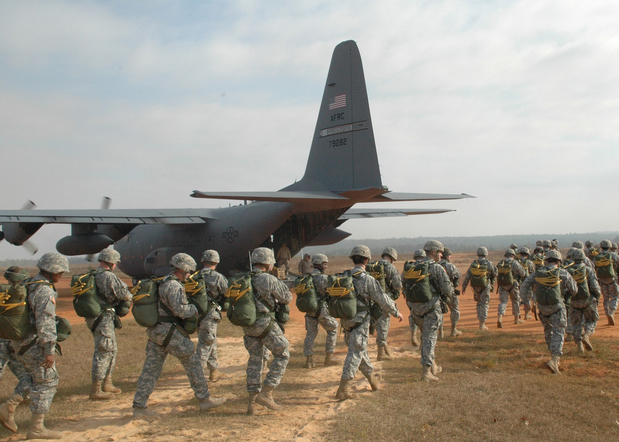 Fifty paratroopers walk to a C-130 with engines running during Operation Toy Drop. The 440th Airlift Wing at Pope Air Force Base, N.C., supported the combined joint exercise with C-130 airlift on Dec. 8, 2007. More than 1,050 paratroopers jumped during the exercise held at the Sicily Drop Zone at Fort Bragg, N.C. (U.S. Air Force photo/Lt. Col. Ann Peru Knabe)