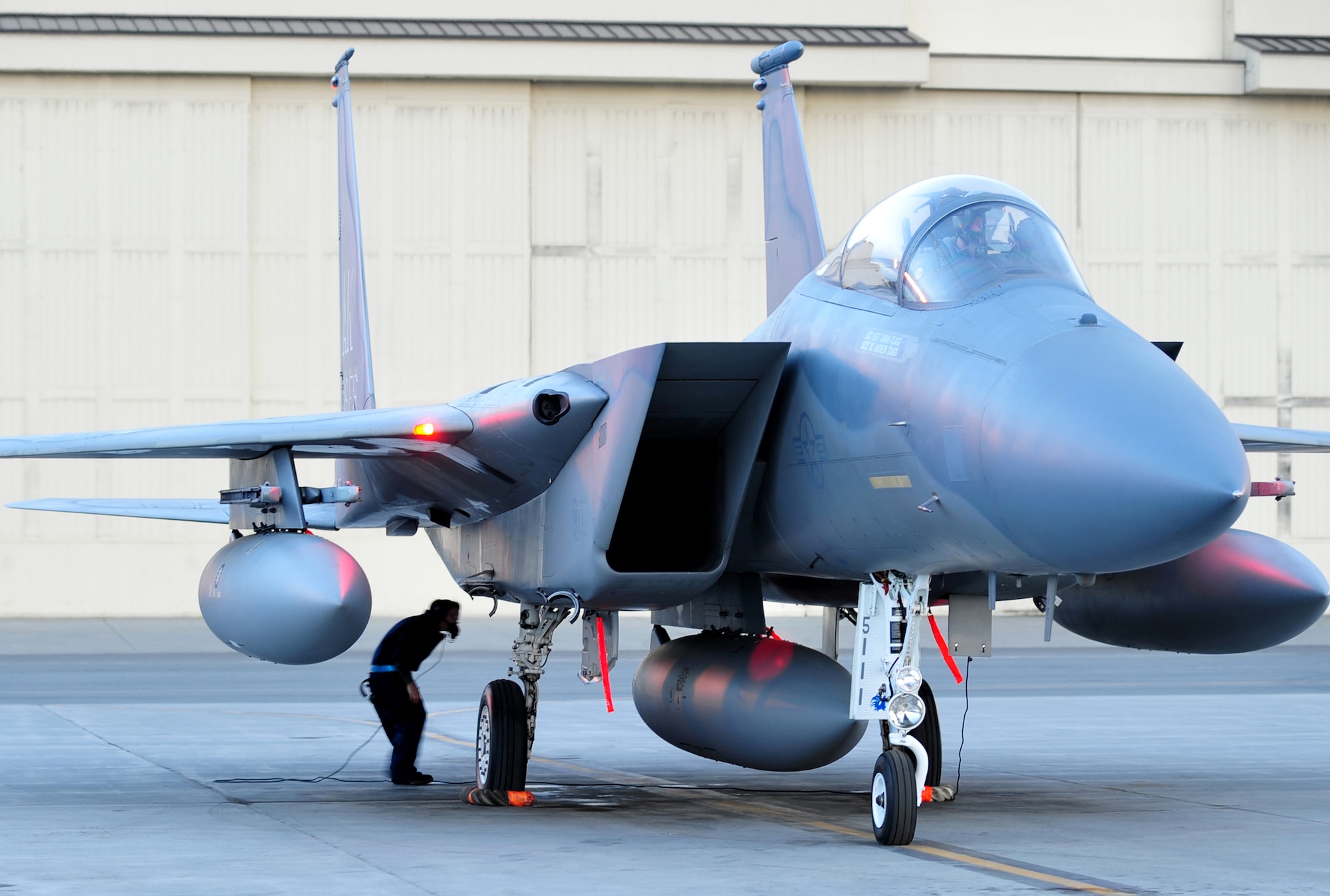 Staff Sgt. Sarah Flagg prepares the 19th Fighter Squadron's F-15 Eagle flagship before its final takeoff at Elmendorf Air Force Base, Alaska, May 13. The aircraft is going to the depot at Robins Air Force Base, Ga., for refurbishing then reassignment. Sergeant Flagg is a crew chief with the 3rd Aircraft Maintenance Squadron. (Air Force photo by Staff Sgt. Brian Ferguson)