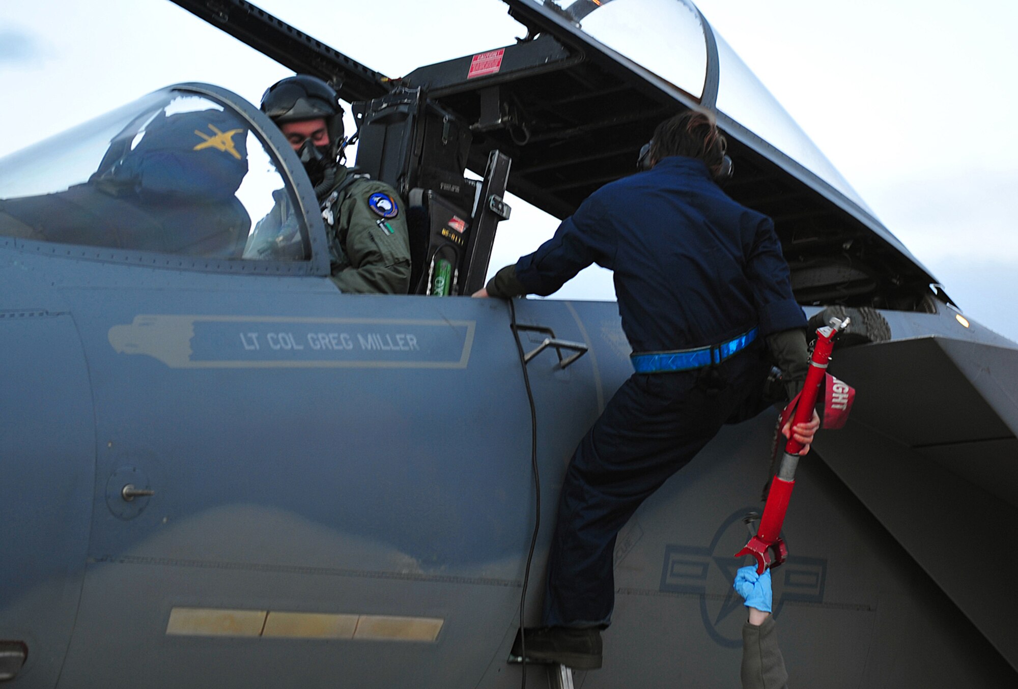 Staff Sgt. Sarah Flagg prepares the 19th Fighter Squadron's F-15 Eagle flagship before its final takeoff at Elmendorf Air Force Base, Alaska, May 13. The aircraft is going to the depot at Robins Air Force Base, Ga., for refurbishing then reassignment. Sergeant Flagg is a crew chief with the 3rd Aircraft Maintenance Squadron. (Air Force photo by Master Sgt. Brian Smith)