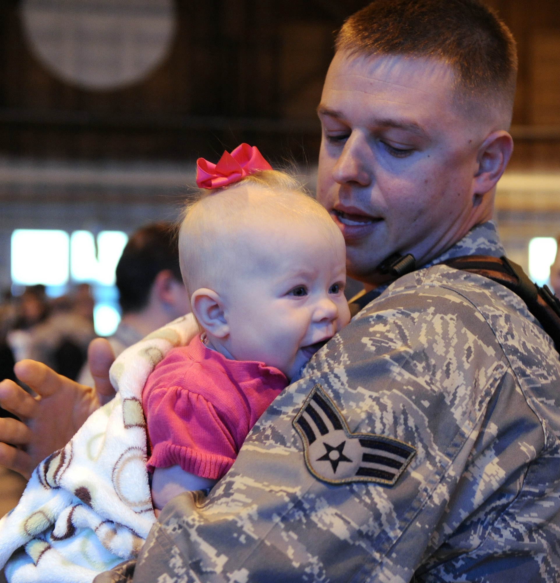 MOUNTAIN HOME AIR FORCE BASE, Idaho -- Senior Airman Jason Roberts, 391st Fighter Squadron, greets his 5 month old daughter, Kaidyn after returning from deployment May 14. 150 Airmen returned from a rotational deployment in support of U.S. Central Command and U.S. Pacific Command. (U.S. Air Force photo by Airman 1stClass Debbie Lockhart)