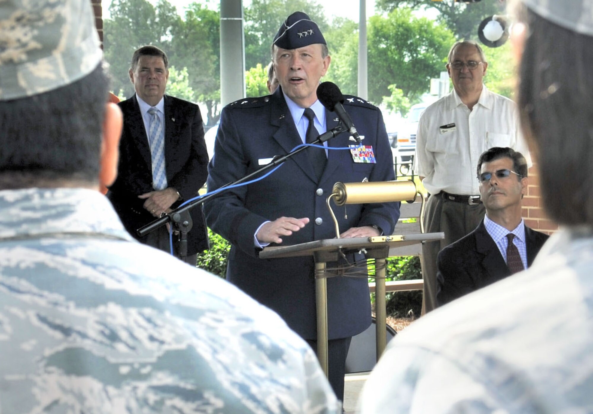 Lt. Gen. Charles E. Stenner Jr., commander of Air Force Reserve Command, speaks at a joint press conference May 14, 2010, announcing this year's Independence Day Concert in Warner Robins, Ga., on July 2. On hand with the general is Warner Robins Mayor Chuck Shaheen, seated at right, and other dignitaries at the city visitors center across the street from Robins Air Force Base. (Courtesy photo)

