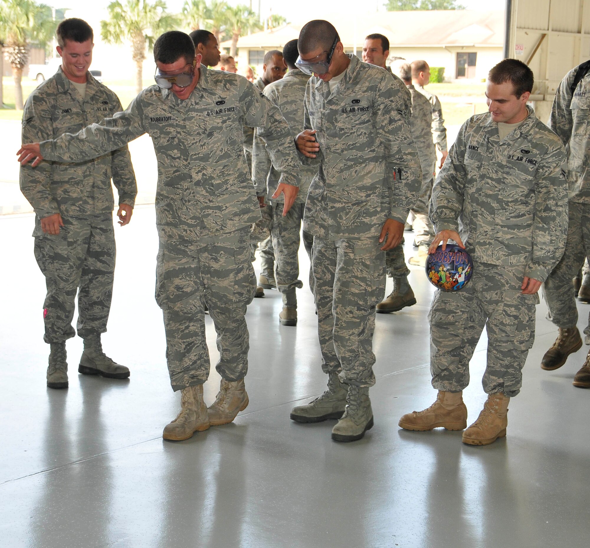 Tyndall Airman attempt to walk in a straight line with "beer goggles" on May 14 at the Safety Day Fair in Hangar One. (U.S. Air Force photo by Lisa Norman)