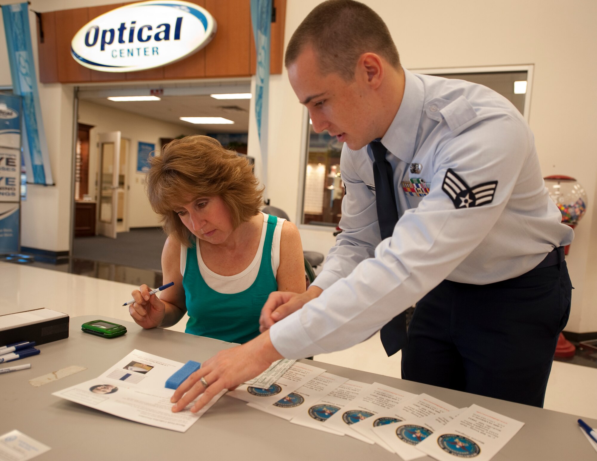 HOLLOMAN AIR FORCE BASE, N.M. -- Senior Airman William Theurer, 49th Operations Support Squadron, assists Lori Blaney, wife of Chief Master Sgt. Kevin Blaney, 49th Operations Group, as she registers to become a donor with the Department of Defense Marrow Program May 7, 2010, at the Base Exchange. More than 1,000 Team Holloman members registered with the Department of Defense Bone Marrow Program during the week-long drive. (U.S. Air Force photo by Airman 1st Class Sondra Escutia / Released)