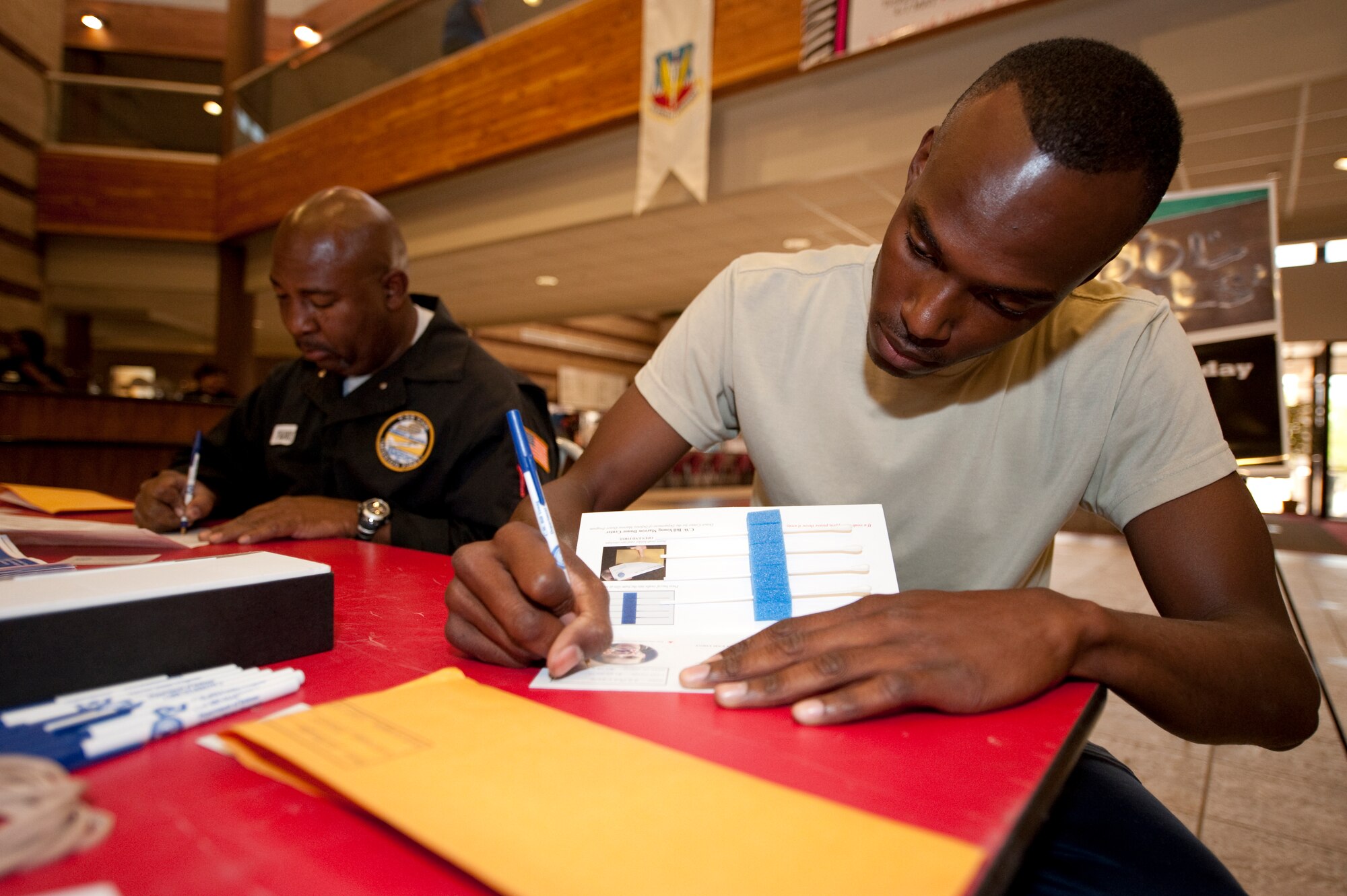 HOLLOMAN AIR FORCE BASE, N.M. -- (From right to left) Airman 1st Class Christopher Nelson, 49th Civil Engineer Squadron, and Parris Veasley, Holloman contractor, fill out consent forms in order to become donors with the Department of Defense Marrow Program during a drive at the Domenici Fitness and Sports Center May 5, 2010. The drive at the fitness center was part of a week-long donor registration drive headed by the 49th Comptroller Squadron. (U.S. Air Force photo by Airman 1st Class Sondra Escutia / Released)