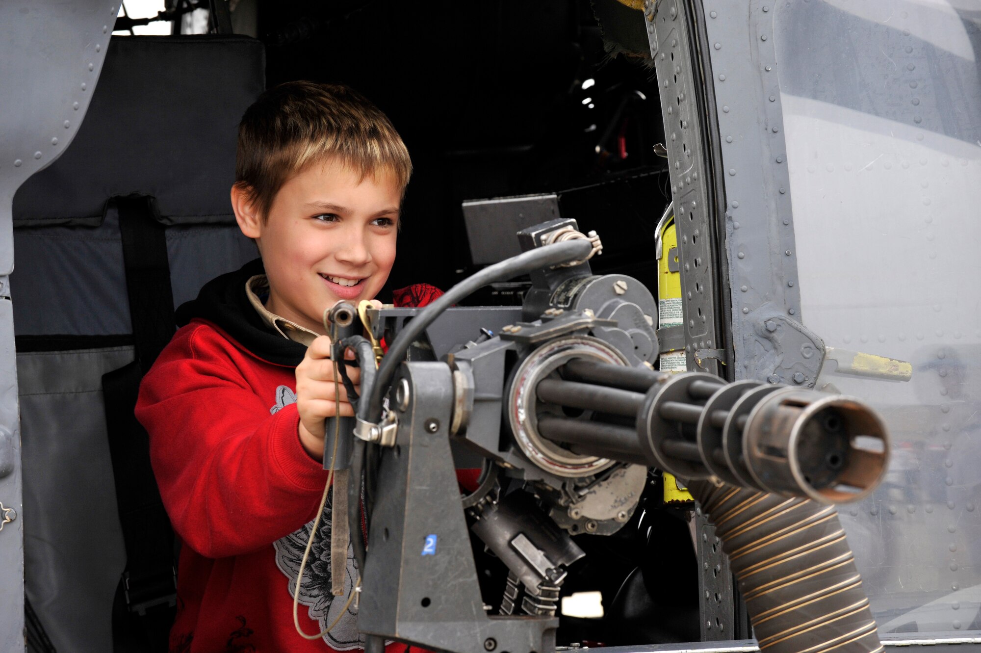 JOINT BASE ANDREWS, Md. - Matthew Duley, 11-years-old, pretends to fire a 7.62 mini gun of an HH 60H Pavehawk stationed out of Moody AFB, Ga. during the Joint Service Open House here May 14. JSOH offers interaction for all members of the joint service community and the public. (U.S. Air Force photo by Staff Sgt. Renae L. Saylock)