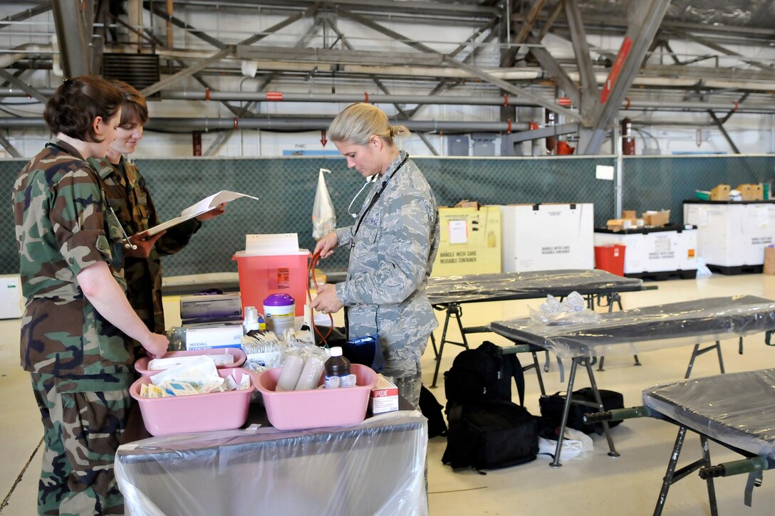 JOINT BASE ANDREWS, Md. - Capt. Katherine Tille and Maj. Ami Parker, doctors with the 779th Medical Group, review a pediatric supply checklist while Lt. Col. Christine Grundel, a nurse with the 779th Surgical Operations Squadron, calls off different supplies at the Joint Service Open House here May 14. The medical group offers medical coverage for the entire event, with a temporary staging facility as well as roaming medics. (U.S. Air Force photo by Staff Sgt. Renae L. Saylock)