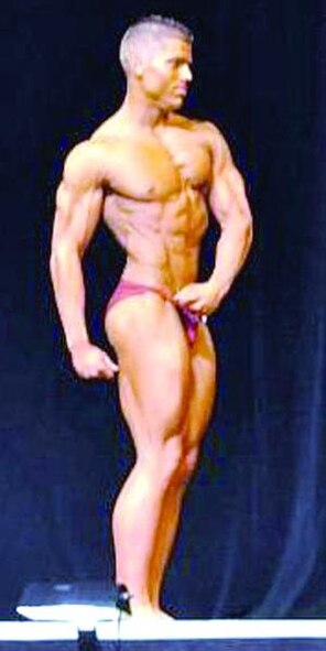 Dustin Biegenwald does a side pose for the 2010 Utah National Bodybuilding and Figure Championships competion, at which he won. (U.S. Air Force photo by Kim Cook)
