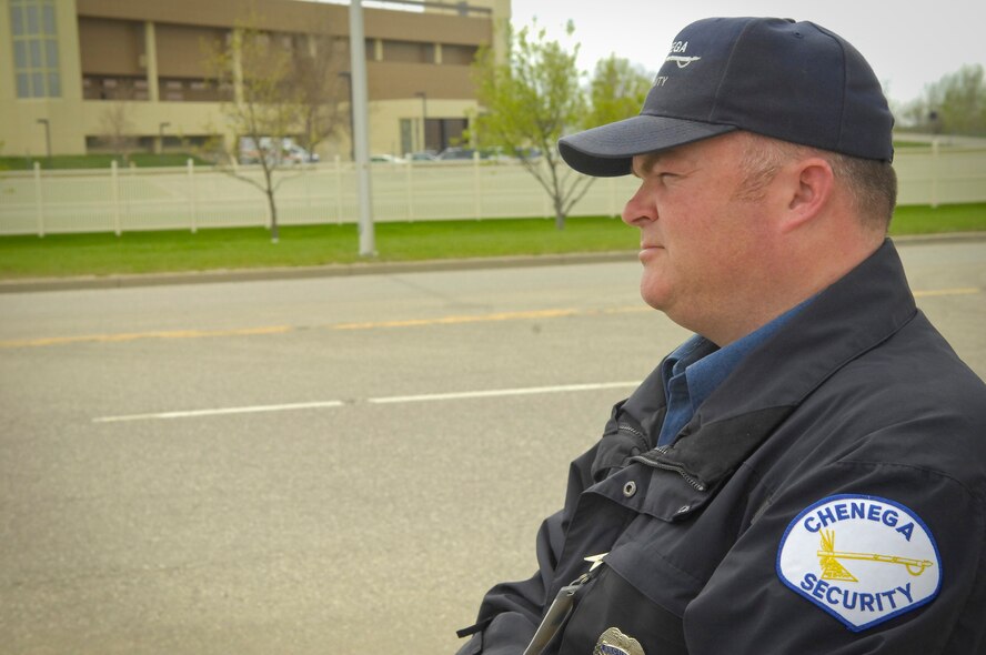MINOT AIR FORCE BASE, N.D. -- Trent Bruns, Chenega Security security officer contracted with the 5th Security Forces Squadron, ensures the safe passage of motor vehicle traffic through the Magic City Gate here May 13. Base security is paramount for the success of both the 91st Missile Wing and 5th Bomb Wing’s missions. (U.S. Air Force photo by Senior Airman Benjamin Stratton)