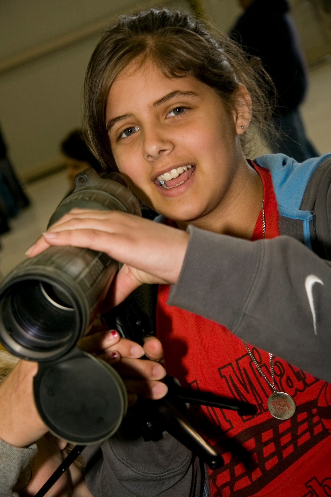 GRISSOM AIR RESERVE BASE, Ind. -- Alyssa Bishop talks with a friend about a spotting scope she is holding during a National Police Week education day held here May 11. Ms. Bishop is a sixth-grader from the North Miami Middle/High School and was able to view equipment used by the 434th Security Forces Squadron and military police. Grissom hosted the event which featured federal, state and local law enforcement agencies. National Police Week starts on May 9 and culminates with National Peace Officer Memorial Day on May 15. (U.S. Air Force photo/Tech. Sgt. Mark R. W. Orders-Woempner)