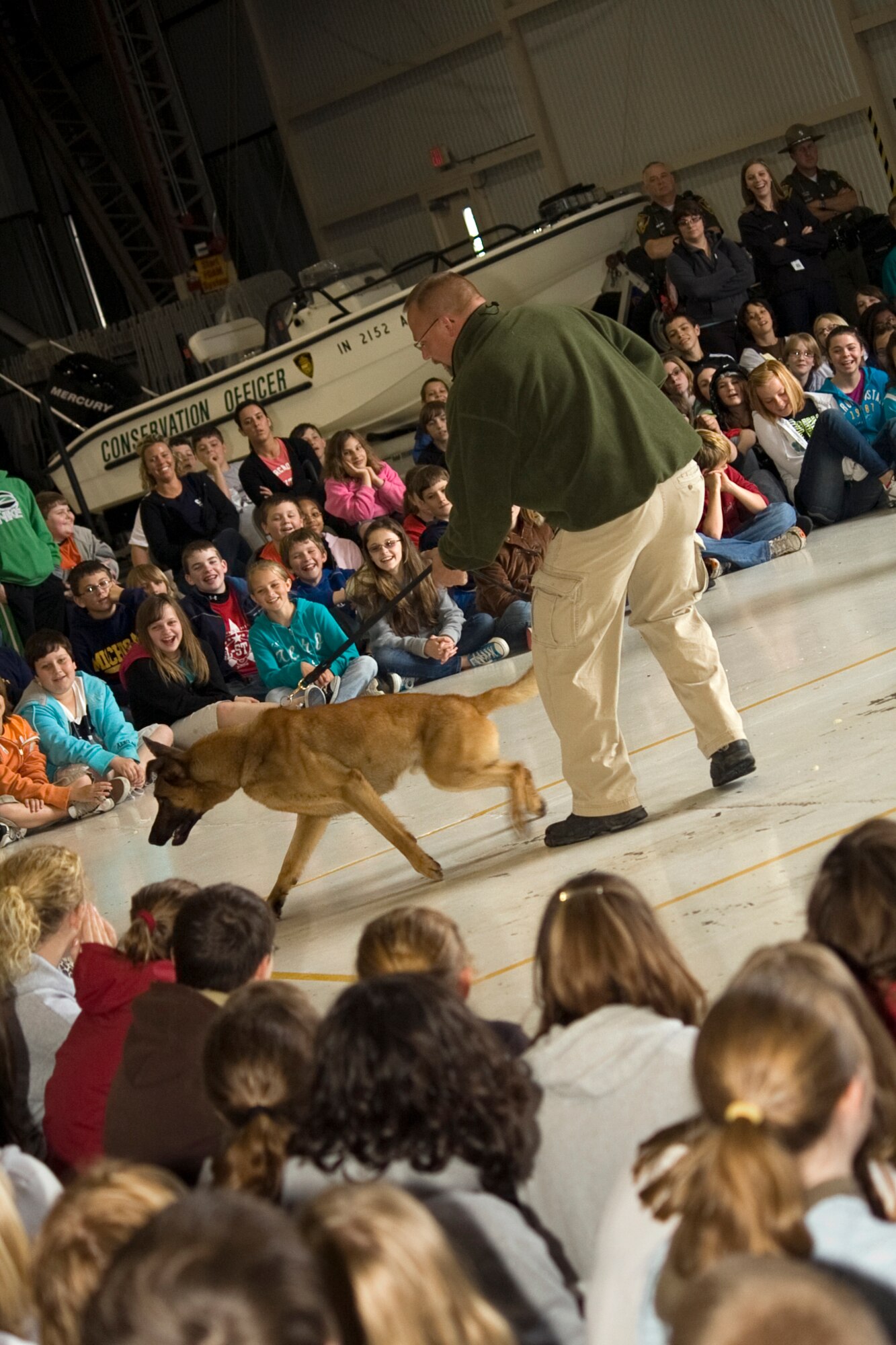 GRISSOM AIR RESERVE BASE, Ind. -- Dan Wachowiak and his K-9, Baco, perform a demonstration in front of students from several local schools during a National Police Week education day held here May 11. The event featured a local dog-training facility as well as federal, state and local law enforcement agencies. National Police Week starts on May 9 and culminates with National Peace Officer Memorial Day on May 15. (U.S. Air Force photo/Tech. Sgt. Mark R. W. Orders-Woempner)